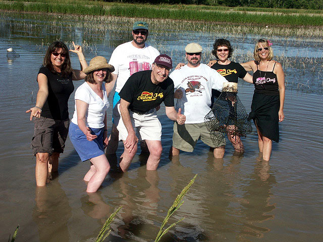 Nancy Covey and tour guests, catching their own crawfish