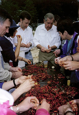 Gil Young offers a crawfish peeling lesson
